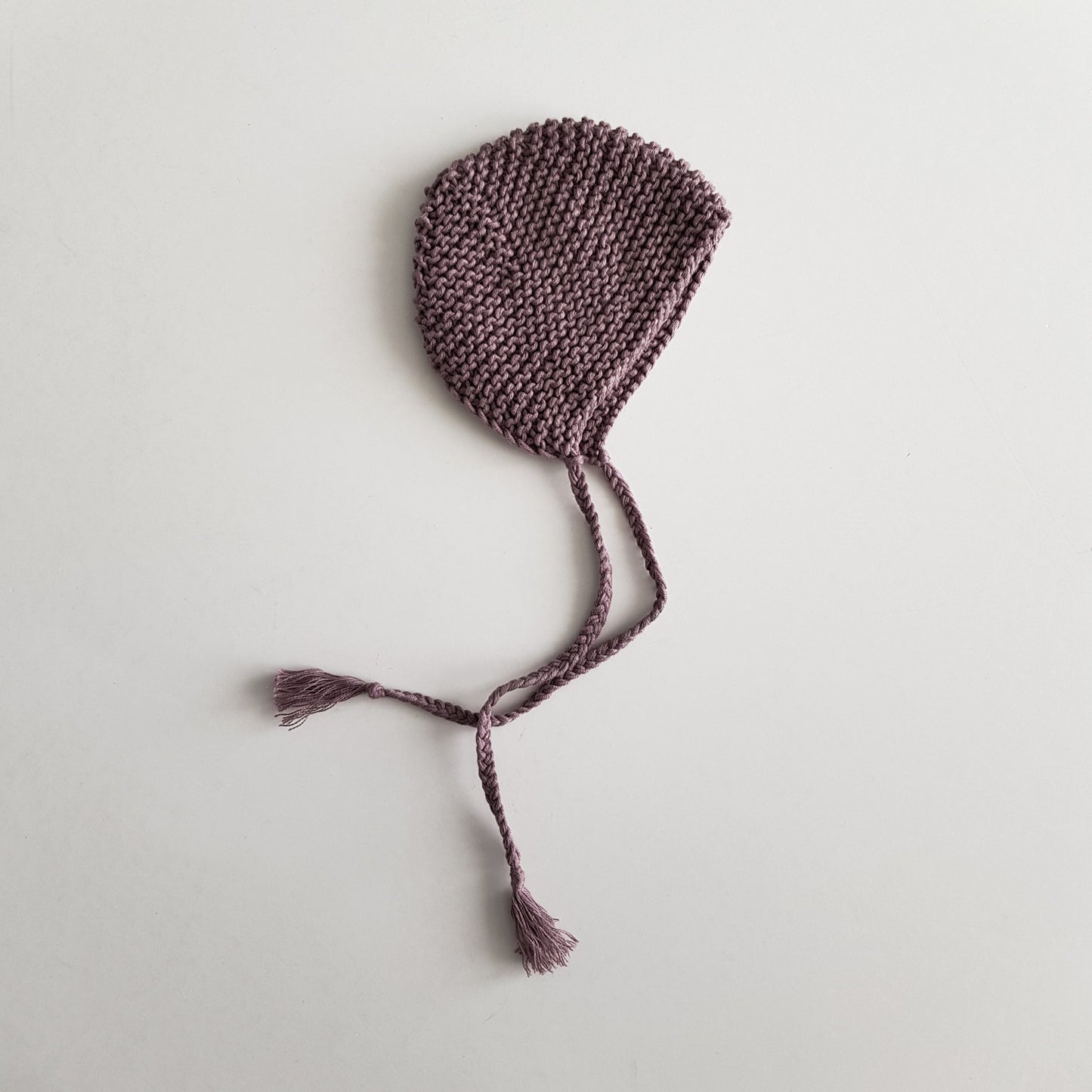 Knitted bonnet for baby doll, mauve